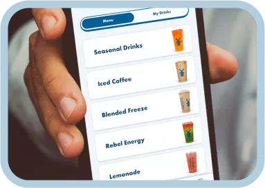 Hands holding smartphone displaying a beverage menu with seasonal drinks including iced coffee and lemonade options.